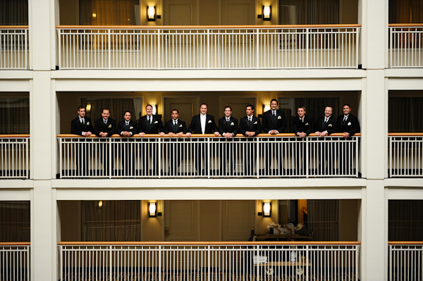 Groomsmen standing on hotel balcony - wedding photo by Kenny Nakai Photography